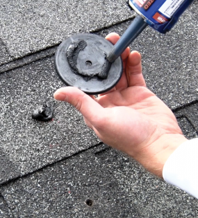 man applying sealant on quickbolt microflashing